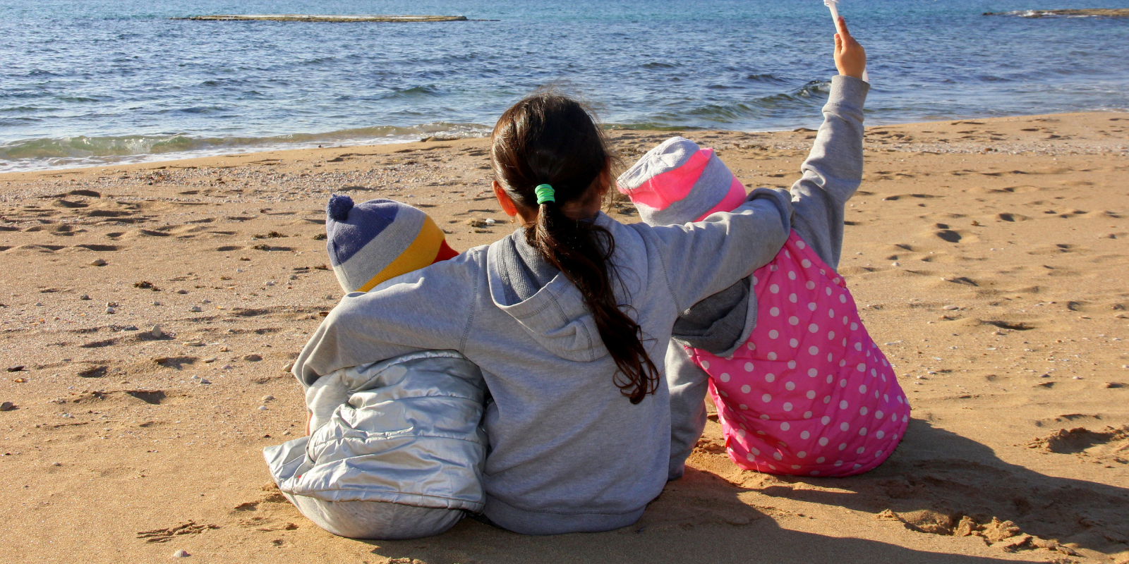 How good and how pleasant it is that brothers dwell together. Israeli siblings at the Mediterranean Sea (Shutterstock.com)