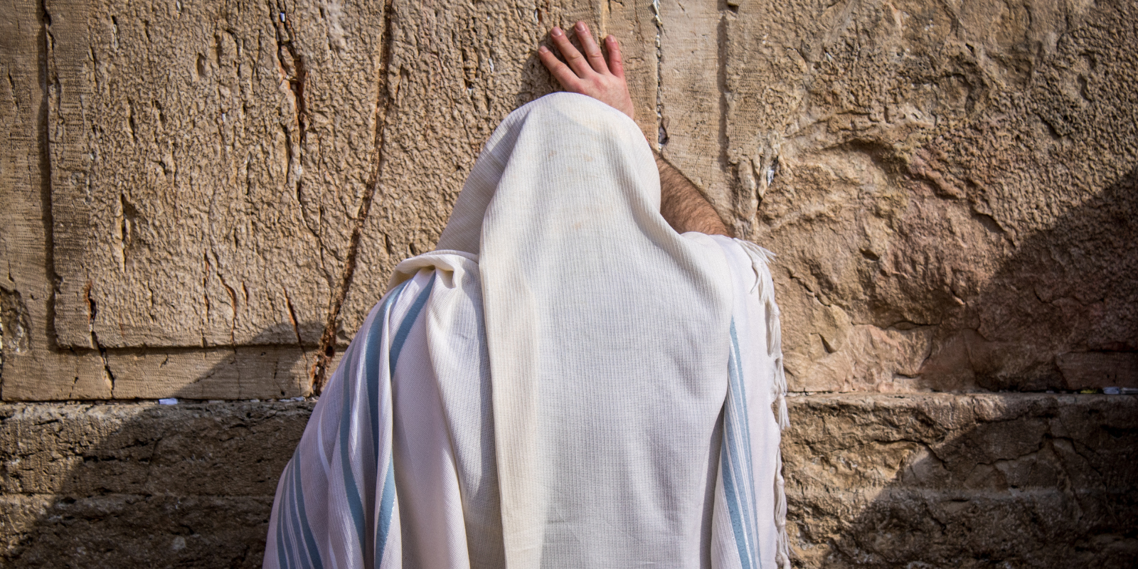 A man prays at the Western Wall in Jerusalem (Shutterstock.com)