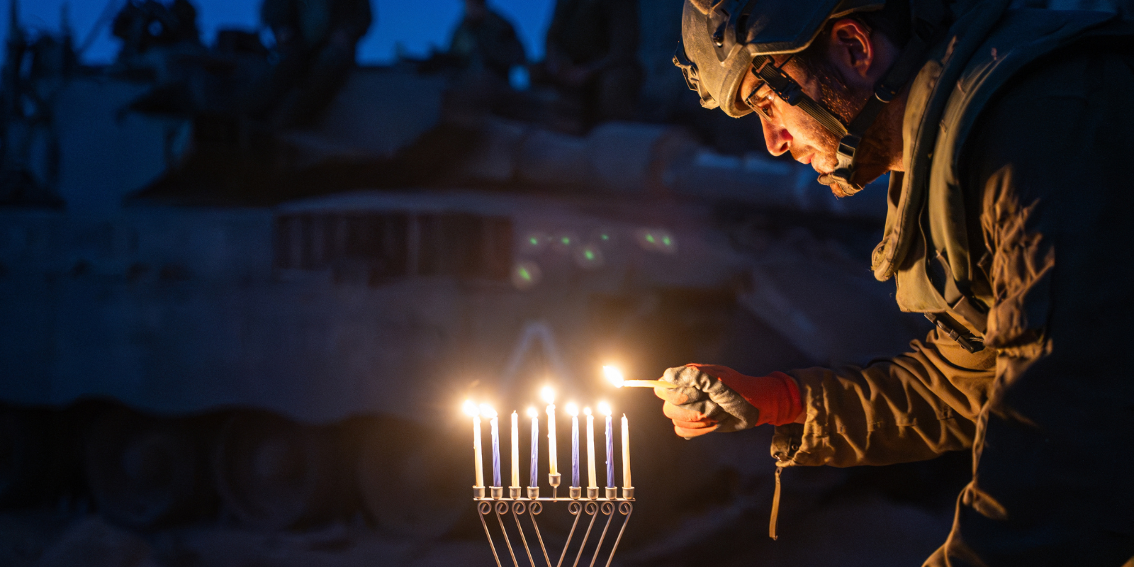 An IDF solider lights Chanukah candles in Gaza (Shutterstock.com)