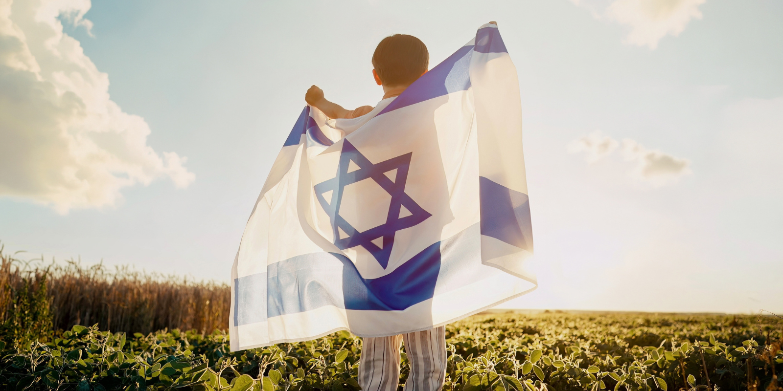 Israeli child proudly wrapped in an Israeli flag (Shutterstock)