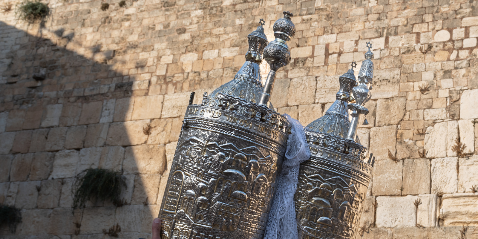 A Torah scroll being lifted at the Western Wall (Yehoshua Halevi, Shutterstock.com)