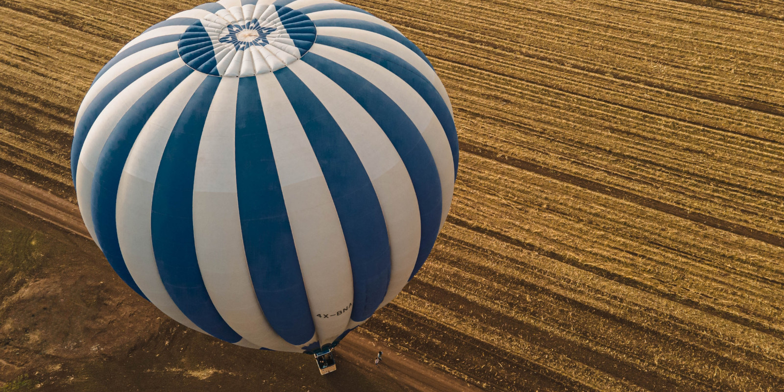 A hot air balloon floating over farmland in Israel (World-Footage, Shutterstock.com)