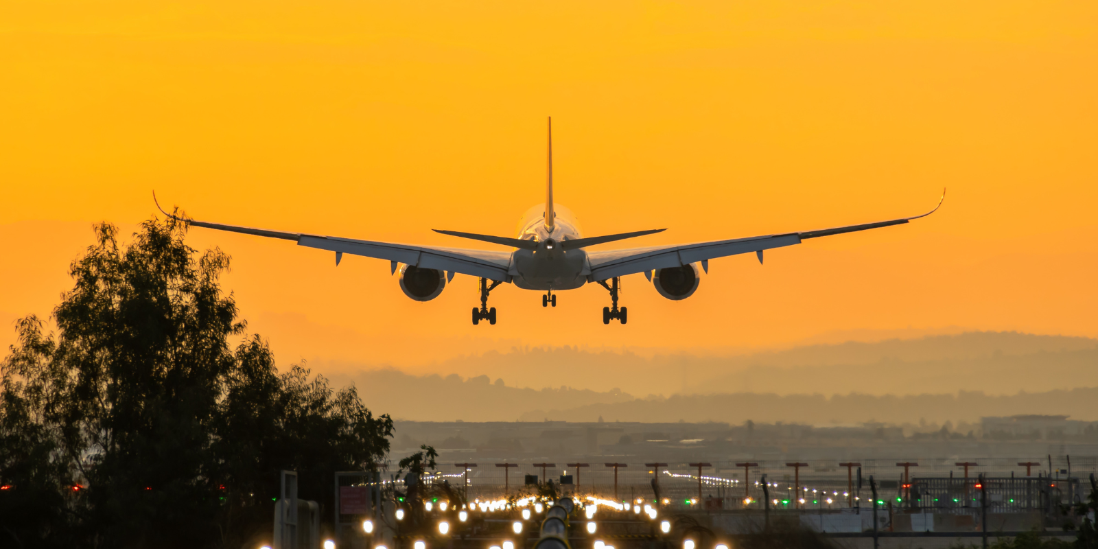 An airplane lands at Ben Gurion airport during sunrise (Avi-G, Shutterstock.com)