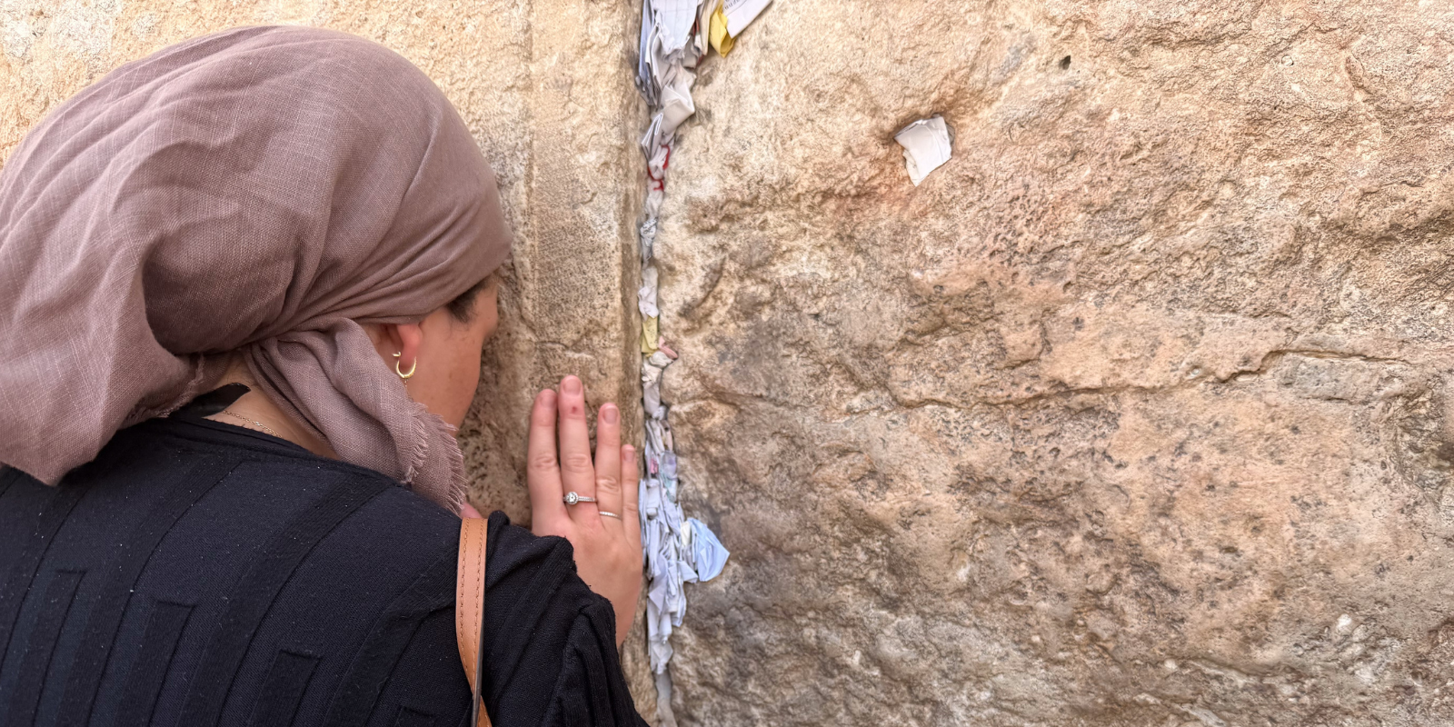 A woman prays at the Western Wall (vered shutzman, Shutterstock.com)